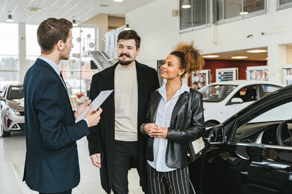 shopper purchasing a car and discussing the total cost including car insurance